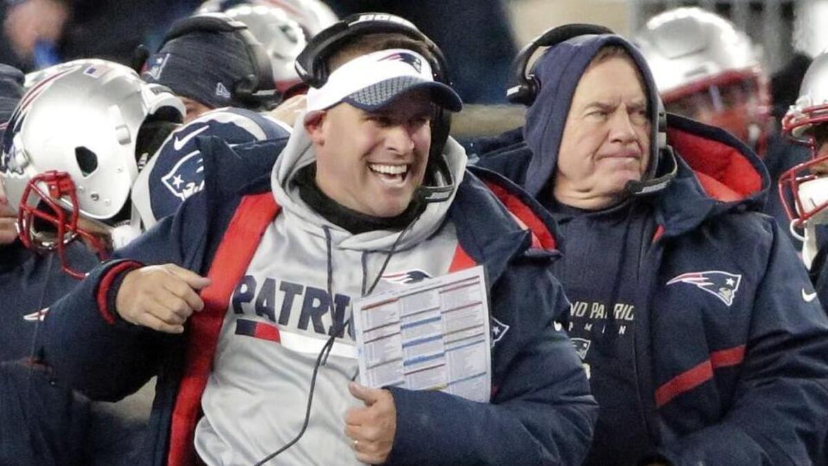 New England Patriots offensive coordinator Josh McDaniels celebrated in front of head coach Bill Belichick during Saturday’s playoff game.