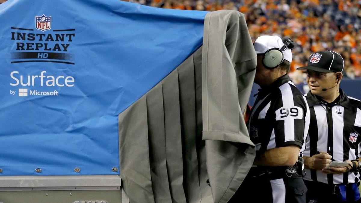 In this Aug. 7, 2014, file photo, referee Tony Corrente watches an instant replay during the second half of an NFL preseason football game in Denver. The NFL is making plans to speed up the pace of games, including changing how video replays are handled.