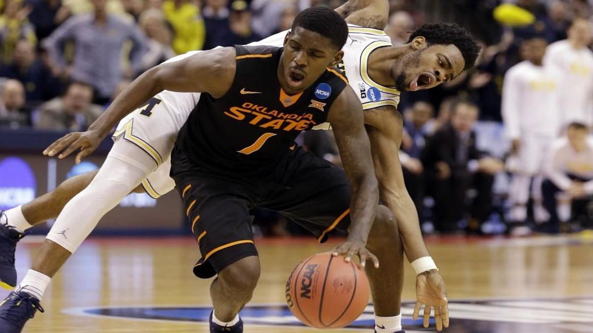 Michigan guard Derrick Walton Jr. fouled Oklahoma State guard Jawun Evans during Friday’s game. Evans hit a meaningless three-pointer that cost bettors some money.