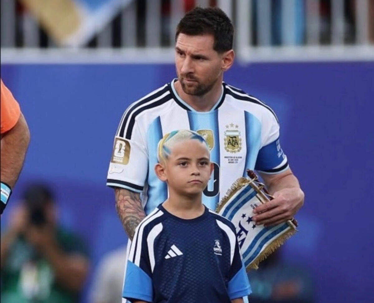 MessiEnoch.jpg Enoch McCleery, 8, of Blue Springs was the player escort for Argentina star Lionel Messi at the World Cup match last month in Kansas City. More than 100 kids from Kansas City walked out with players.