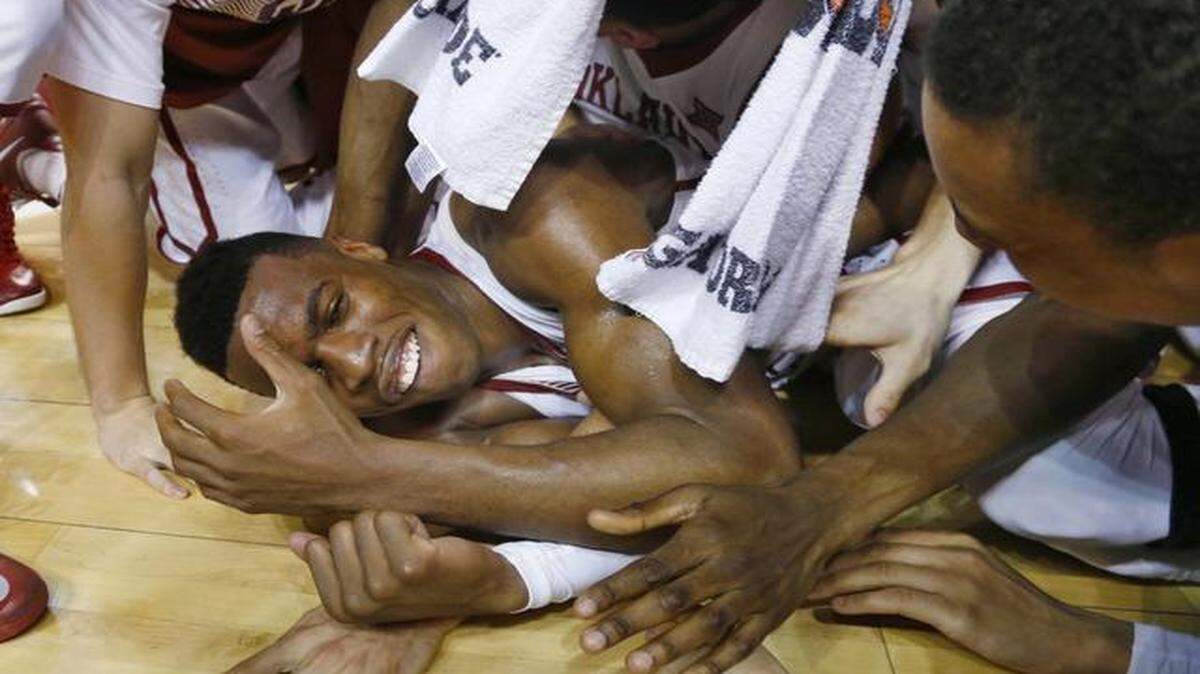 
Sooners guard Buddy Hield (bottom) celebrated with his teammates after Oklahoma defeated Kansas 75-73.
