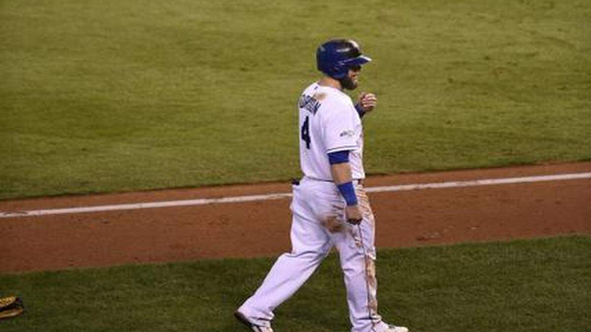
Kansas City Royals left fielder Alex Gordon who was on third base walked back to the dugout as the San Francisco Giants celebrate after winning 3-2 in game seven of the World Series on Oct. 29, 2014.
