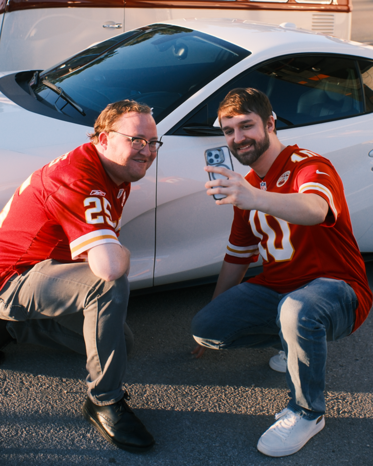 Fans posed by a car