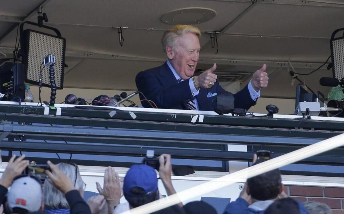 Los Angeles Dodgers broadcaster Vin Scully gestured to fans during the seventh inning stretch of Saturday’s game.