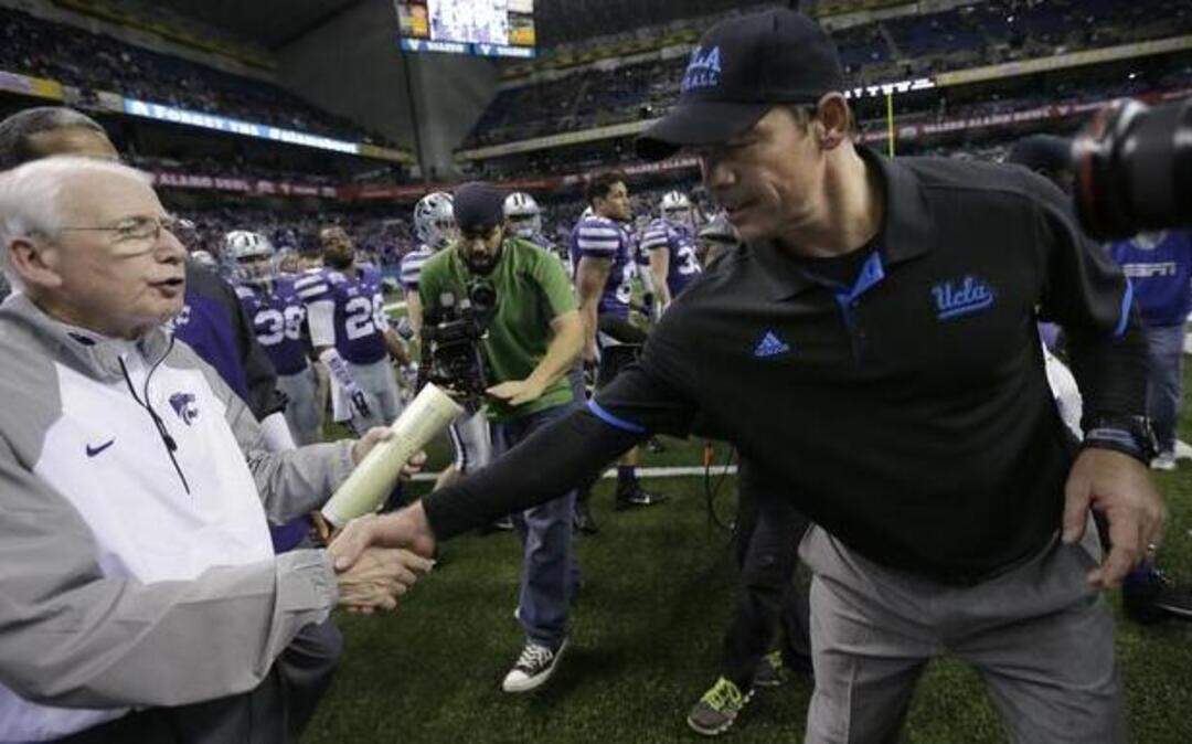 
Kansas State head coach Bill Snyder (left) and UCLA head coach Jim Mora didn’t meet for long after the Bruins beat the Wildcats in the Alamo Bowl.

