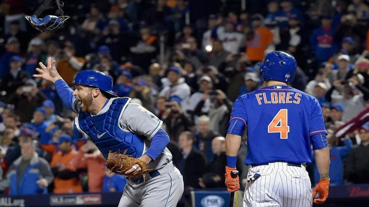 Kansas City Royals catcher Drew Butera threw his mask but not his glove as he celebrated in front of the Mets’ Wilmer Flores.
