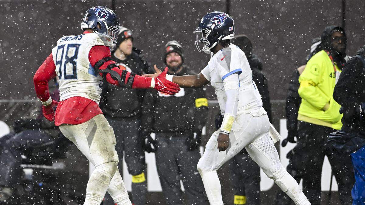 Cam Ward and Jeffery Simmons of the Tennessee Titans celebrate a touchdown during the fourth quarter at Huntington Bank Field on Dec. 7, 2025 in Cleveland, Ohio.