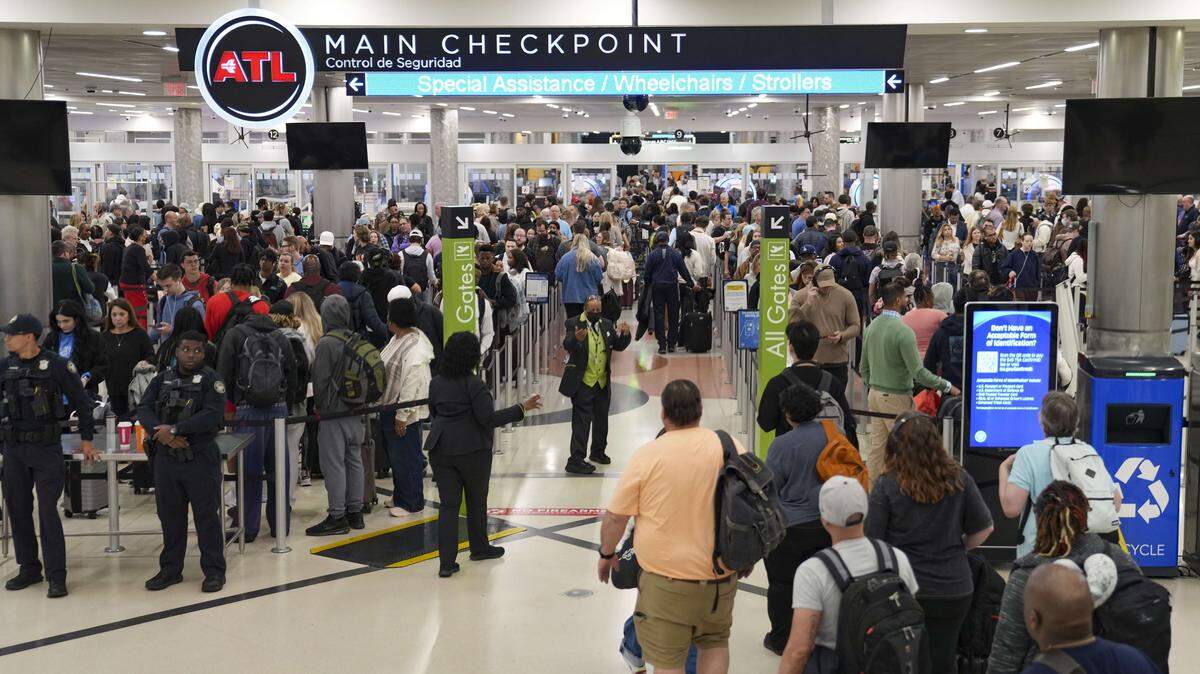 Travelers wait in long lines early in the morning at Atlanta Hartsfield-Jackson International Airport on March 26, 2026 in Atlanta, Georgia. 
