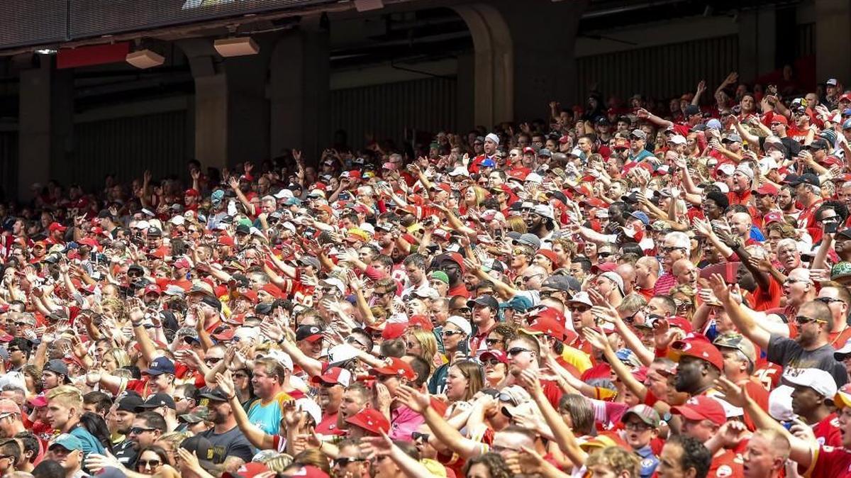 Kansas City Chiefs fans do the tomahawk chop at Arrowhead Stadium.