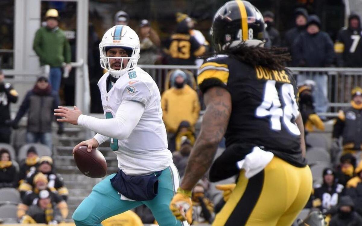 Miami Dolphins quarterback Matt Moore rolled out with Pittsburgh Steelers outside linebacker Bud Dupree in pursuit during Sunday’s game.
