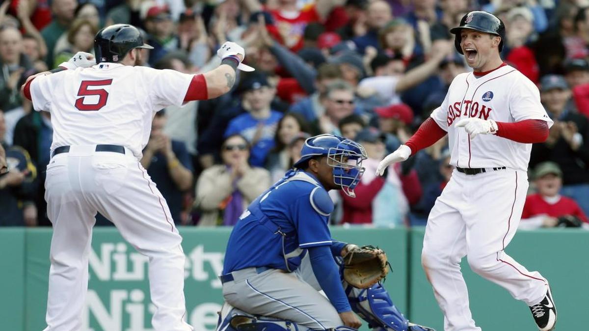 Boston Red Sox’s Daniel Nava (right) celebrated his three-run home run with teammate Jonny Gomes (left) as Kansas City Royals’ catcher Salvador Perez looked on in the eighth inning of a game on April 20, 2013. The Red Sox won 4-3.