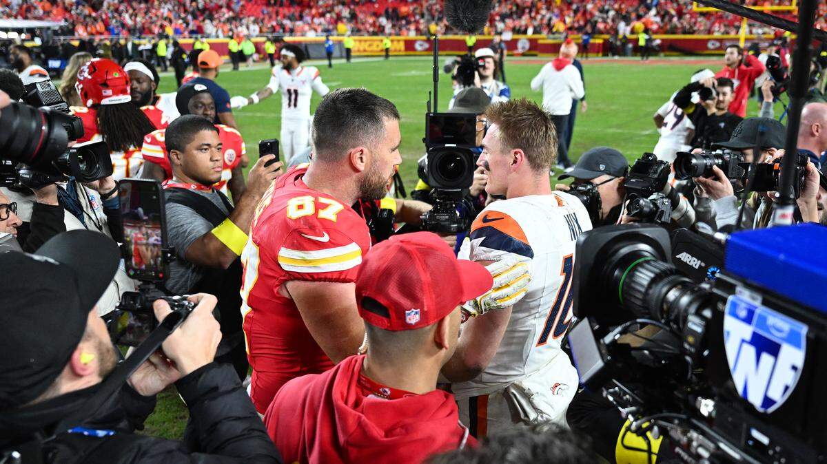 Chiefs tight end Travis Kelce and Broncos quarterback Bo Nix met on the field following the Broncos 20-13 win at Arrowhead Stadium on Dec. 25, 2025 in Kansas City, Missouri.