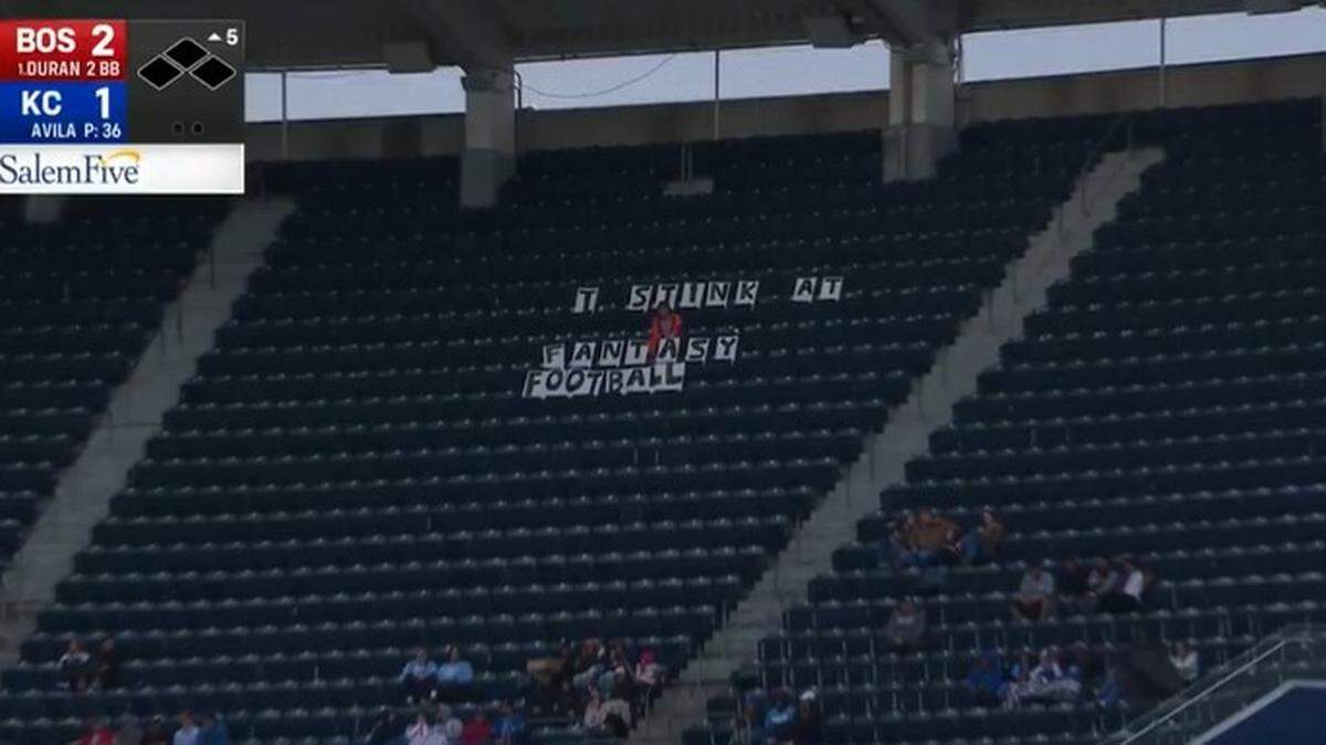 A fan lost a fantasy football league and let the world know it at the Royals-Red Sox game.