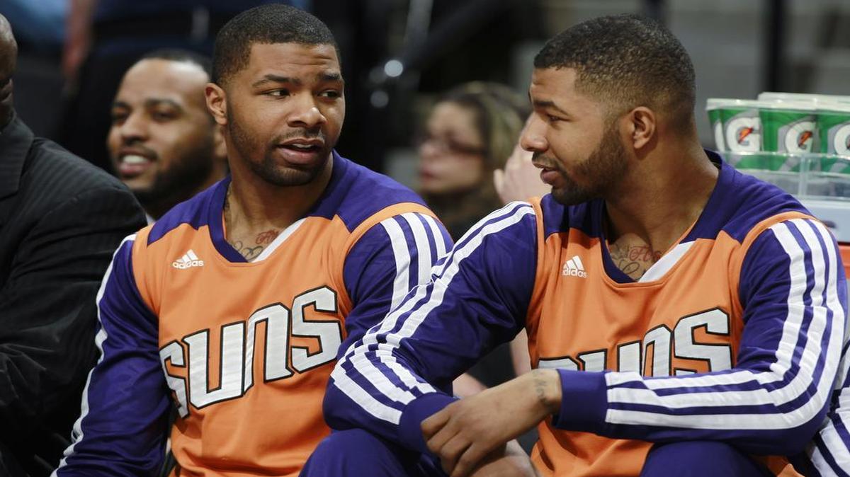 
In this Feb. 18, 2014 photo, Phoenix Suns forwards Marcus Morris (left) and his twin brother Markieff talked on bench.
