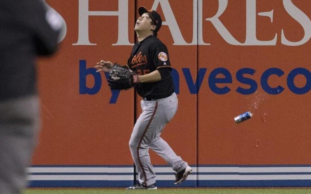 Baltimore Orioles outfielder Hyun Soo Kim gets under a fly ball as a can fell near him during the American League Wild Card game last October.