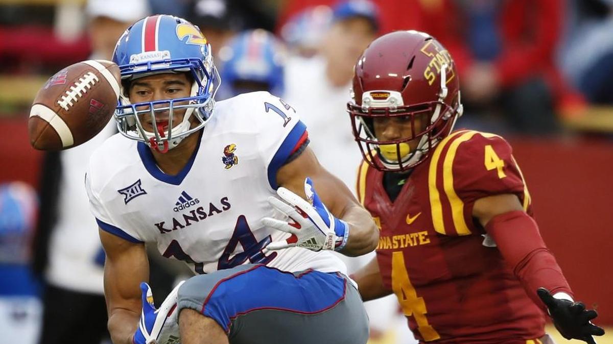 Kansas wide receiver Kerr Johnson Jr. dropped a pass in front of Iowa State defensive back Evrett Edwards during Saturday’s game in Ames, Iowa.