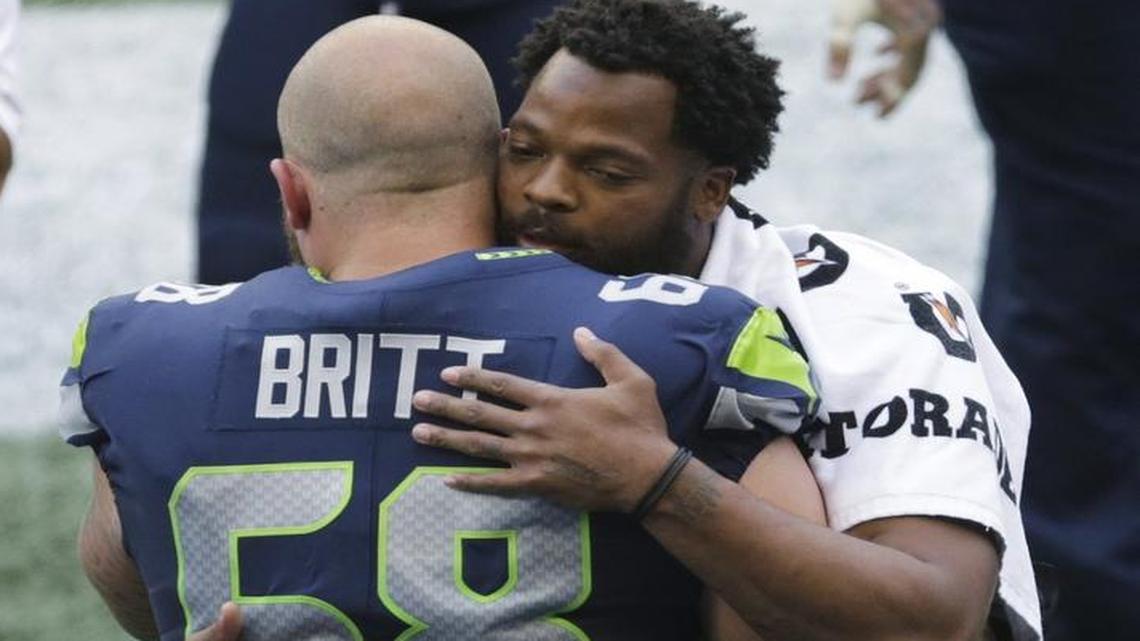 Seattle Seahawks center Justin Britt hugged defensive end Michael Bennett before Friday’s game.