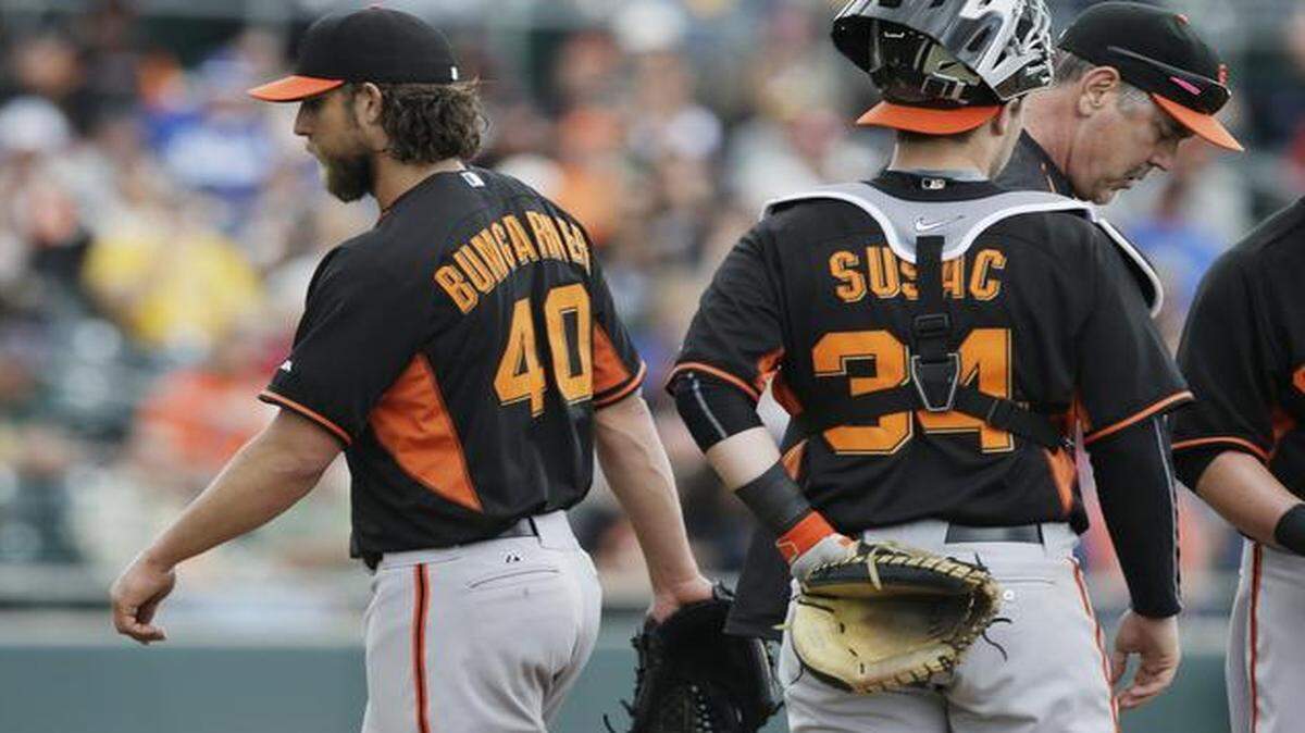 
San Francisco pitcher Madison Bumgarner walked off the mound after being taken out by manager Bruce Bochy during the second inning of a spring-training game against the Oakland Athletics on Tuesday in Mesa, Ariz.
