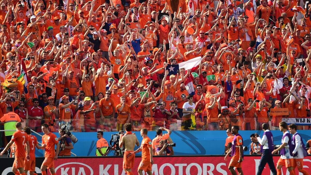 Netherlands players celebrate with fans after winning a Group B football match between Netherlands and Chile at the Corinthians Arena in Sao Paulo during the 2014 FIFA World Cup on June 23, 2014. Netherlands won 2-0.
