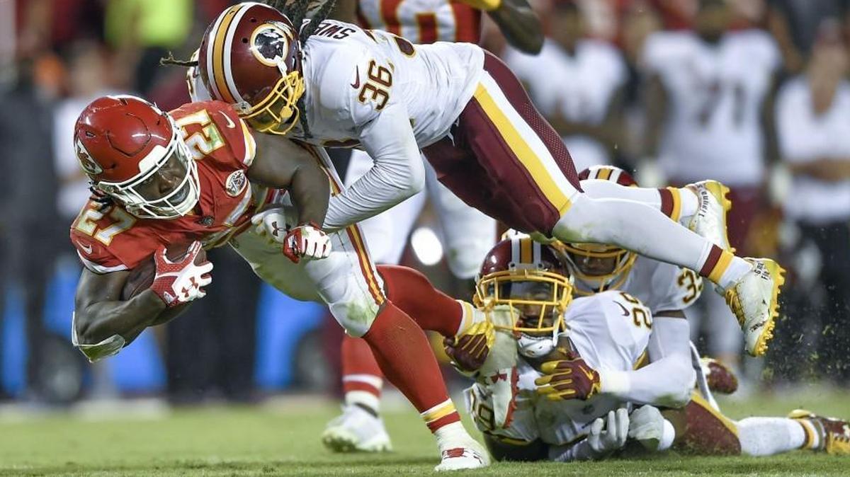 After a 16-yard run, Kansas City Chiefs running back Kareem Hunt was tackled by Washington safety D.J. Swearinger (top), cornerback Kendall Fuller (29) and safety Montae Nicholson during a game last year.