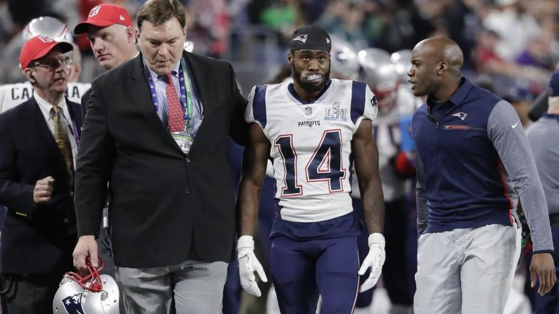 New England Patriots trainers escort wide receiver Brandin Cooks off the field during Super Bowl LII.