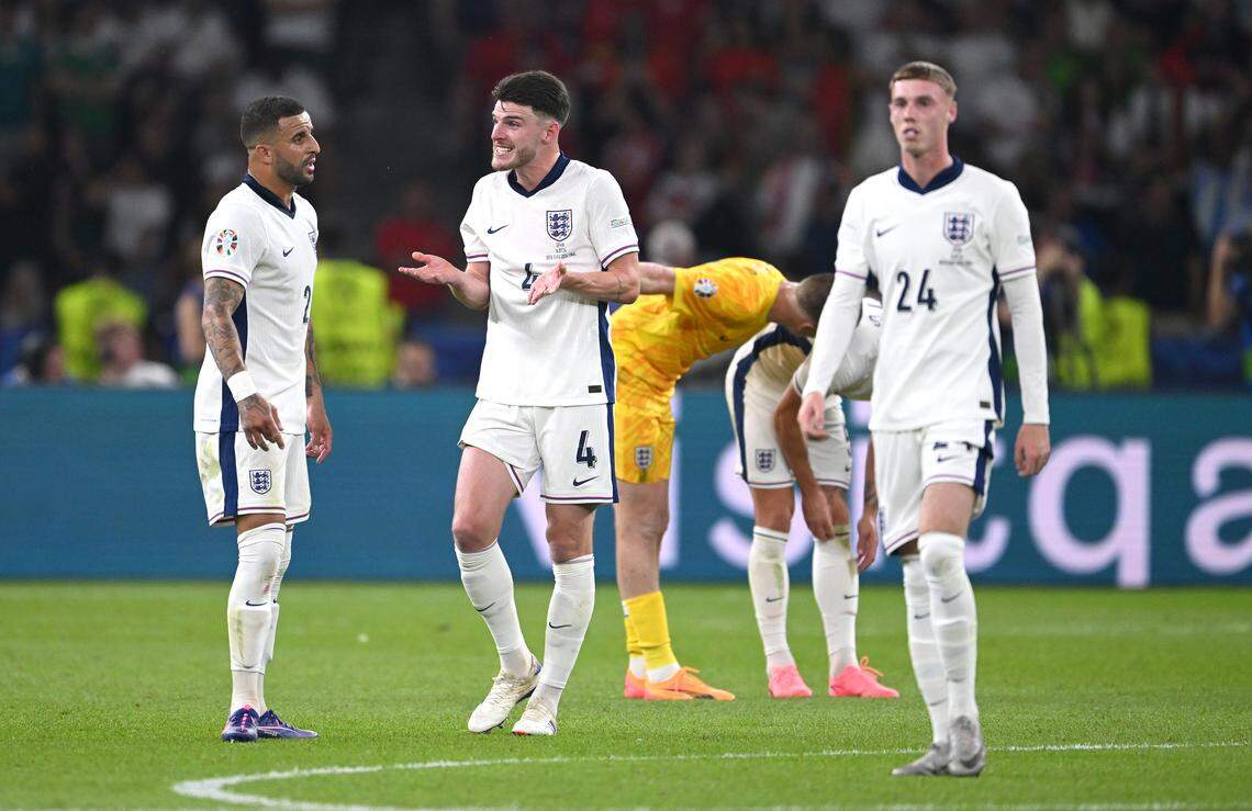England players Declan Rice and Kyle Walker react as Cole Palmer looks on after the second Spain goal during the UEFA EURO 2024 final match between Spain and England at Olympiastadion on July 14, 2024 in Berlin, Germany.