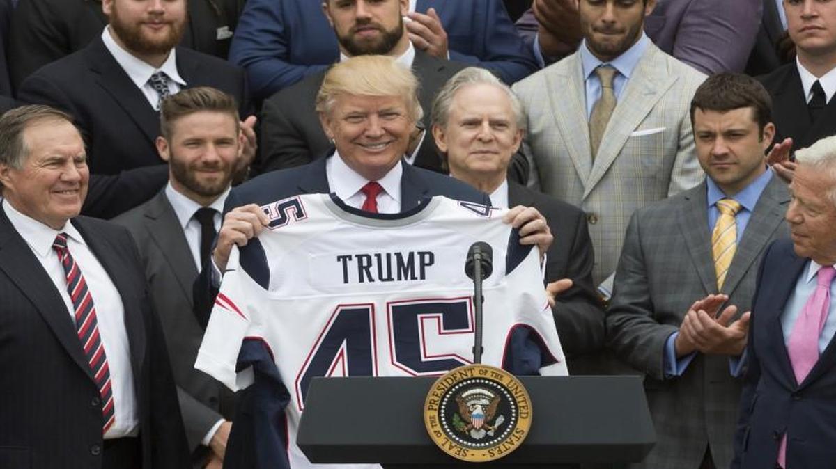President Donald Trump held a Patriots Super Bowl jersey next to coach Bill Belichick (left) and owner Robert Kraft (right) at the White House on Wednesday.