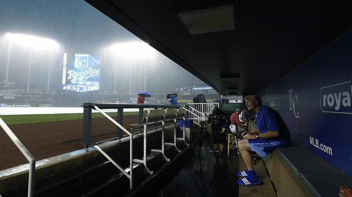 
Kansas City Royals first base coach Rusty Kuntz watched as heavy rain fell before Monday's game against the Tampa Bay Rays on July 6, 2015 at Kauffman Stadium.
