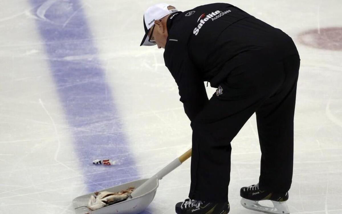 An ice worker removed a fish during the second period in Game 1 of the Stanley Cup Final between the Pittsburgh Penguins and the Nashville Predators on Monday in Pittsburgh.