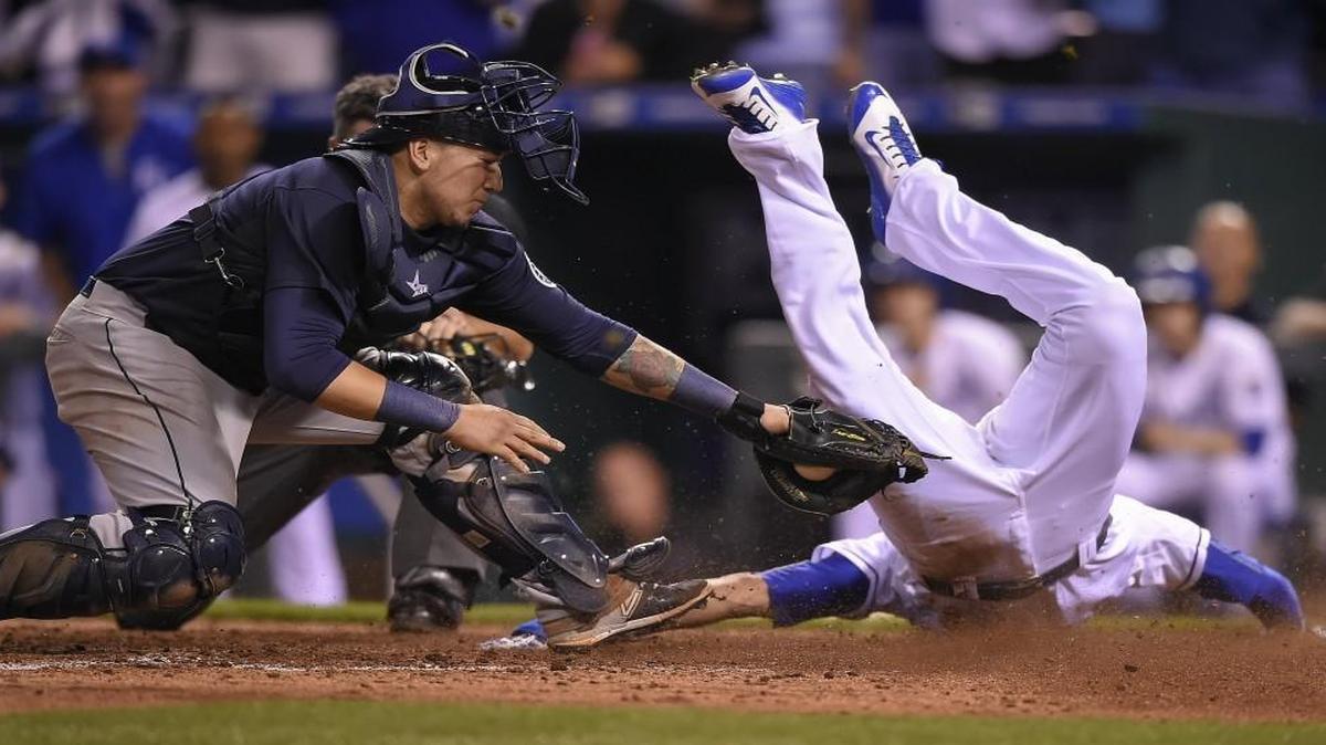 
Kansas City Royals right fielder Paulo Orlando scored the winning run past the tag of Seattle Mariners catcher Jesus Sucre on Wednesday.
