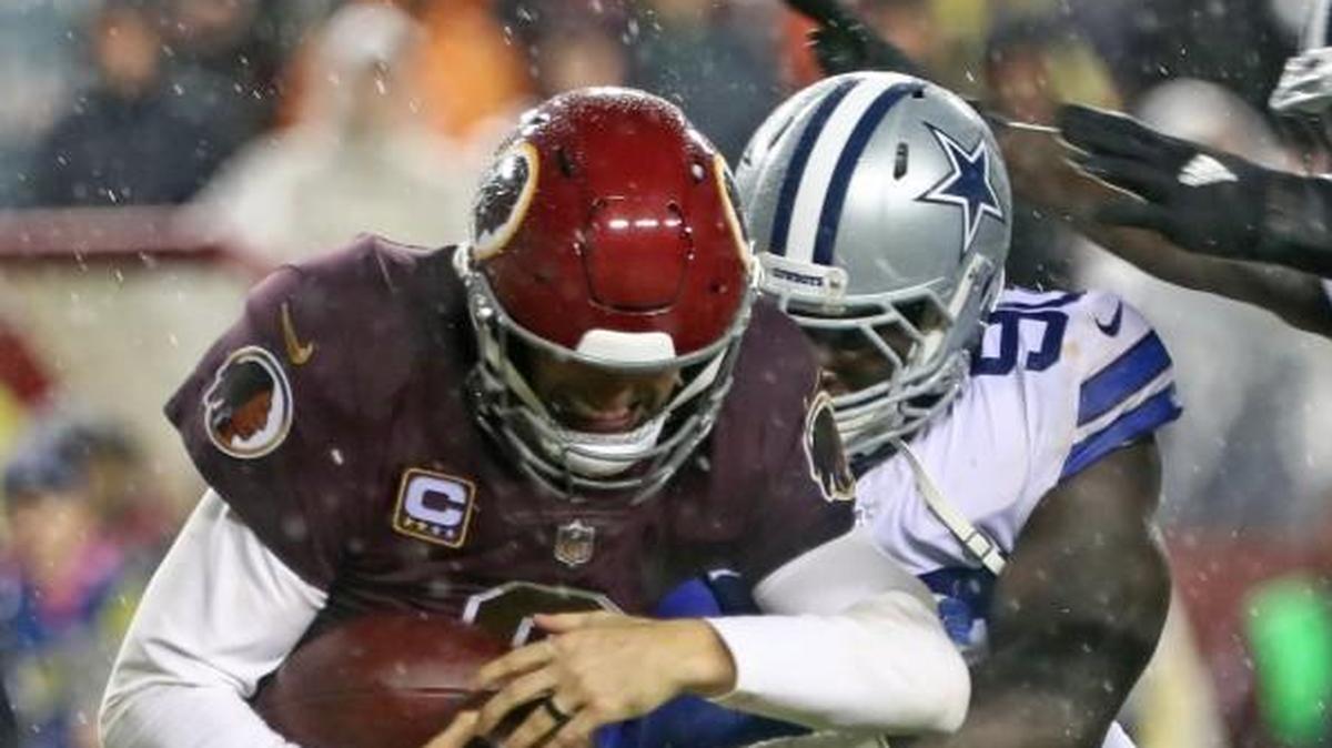 Dallas Cowboys defensive end Demarcus Lawrence and outside linebacker Jaylon Smith sacked Washington quarterback Kirk Cousins during Sunday’s game.