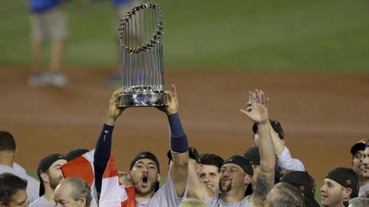 The Houston Astros star Carlos Correa celebrated with the trophy after their World Series win against the Los Angeles Dodgers on Wednesday.