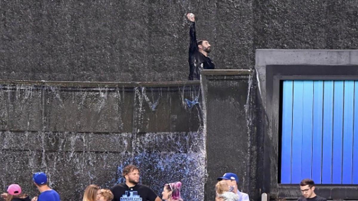 A fan jumped into the fountains and got a baseball that was hit there by the Royals’ Brandon Moss.