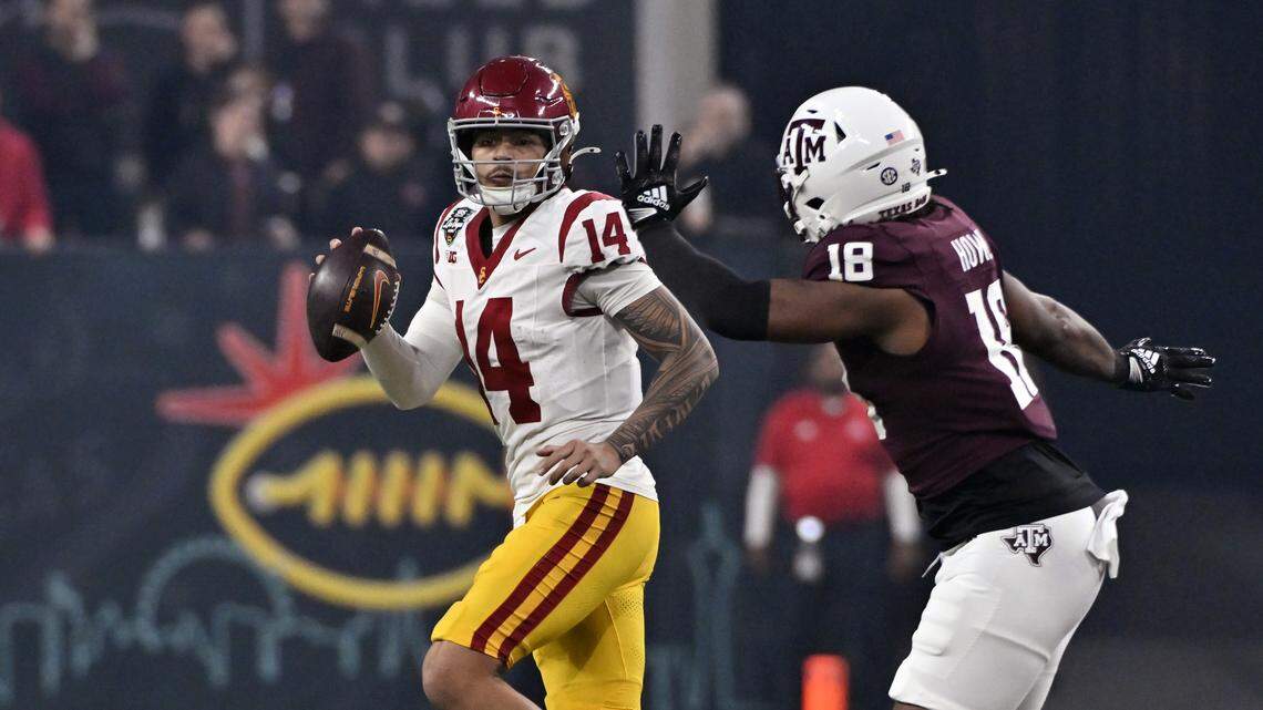 Jayden Maiava #14 of the USC Trojans looks to pass under pressure from Cashius Howell #18 of the Texas A&M Aggies during first half of the SRS Distribution Las Vegas Bowl at Allegiant Stadium on Dec. 27, 2024 in Las Vegas, Nevada.