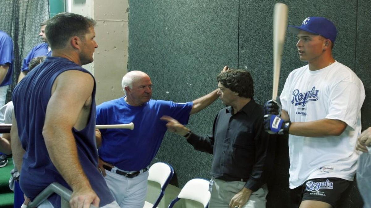 In 2004, Billy Butler (with bat) visited with Royals Mike Sweeney (left) at the indoor batting cage during a visit to Kauffman Stadium.