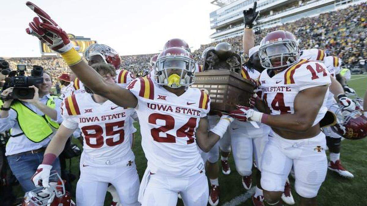 
Iowa State players celebrated with the Cy-Hawk trophy after defeating Iowa 20-17 in September.
