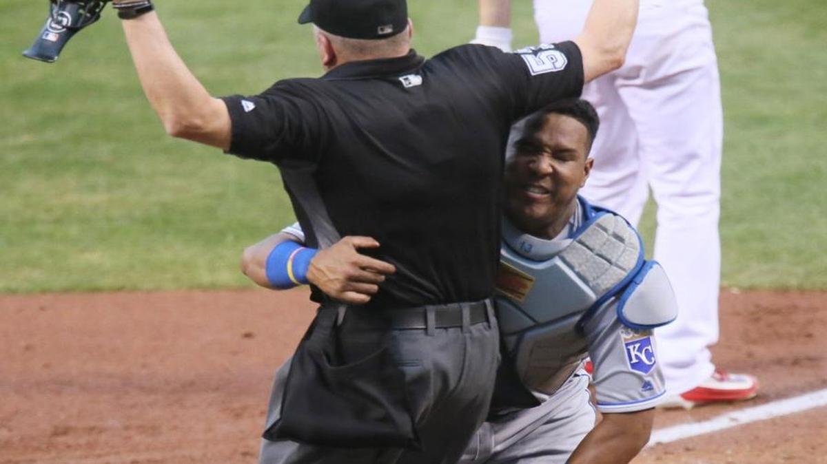 Kansas City Royals catcher Salvador Perez collided with home plate umpire Mike Everitt as he turns to chase a foul ball off the bat of the St. Louis Cardinals pitcher Mike Leake during Thursday’s game.