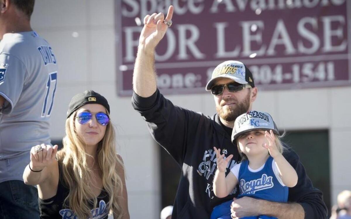 Royals pitcher Wade Davis, accompanied by his wife, Katelyn and daughter, Sully, waved to Royals fans during the World Series victory parade.