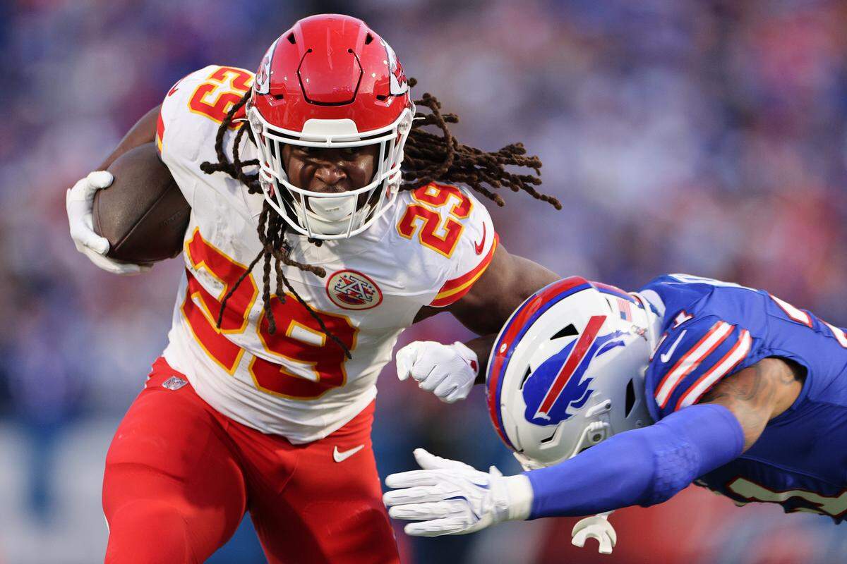 Kansas City Chiefs running back Kareem Hunt, left, collects first-half yardage past Jordan Poyer of the Buffalo Bills during an NFL Week 9 game at Highmark Stadium in Orchard Park, New York, on Sunday, Nov. 2, 2025.