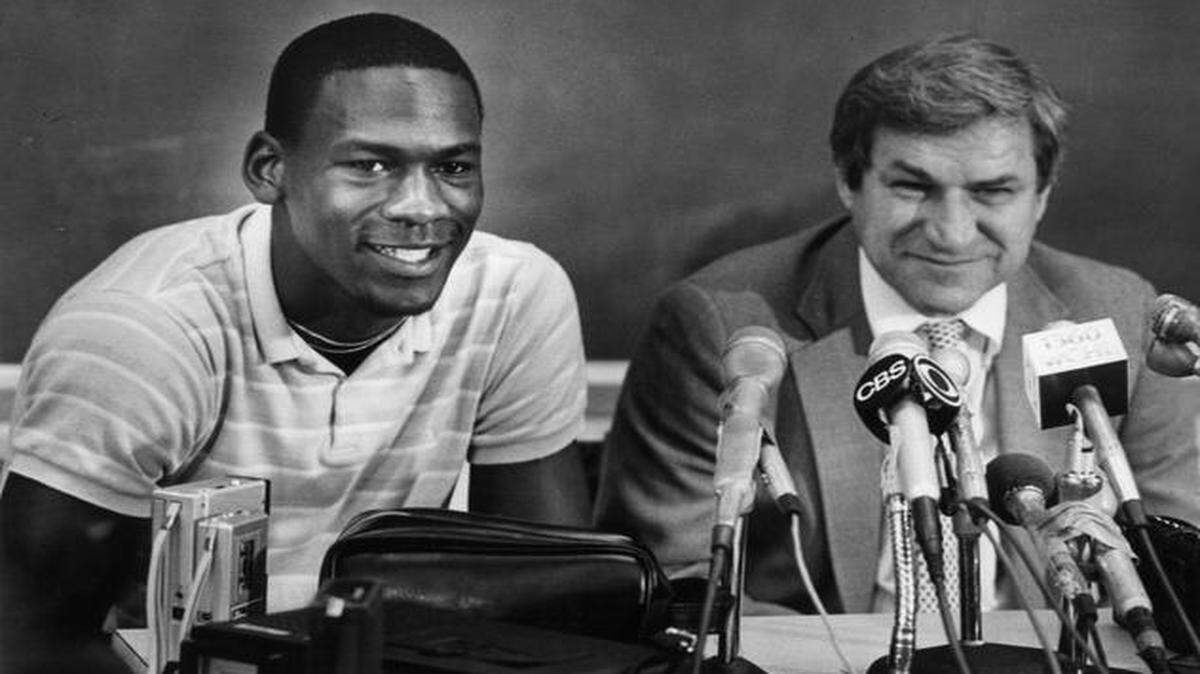 
Michael Jordan smiled along with coach Dean Smith when Jordan announced at a 1984 news conference that he was going pro.

