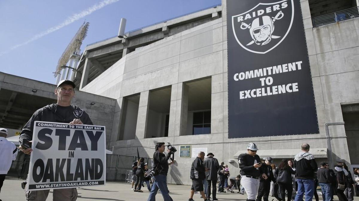 John P. Kelleher held up a sign outside the Oakland Coliseum before the start of a rally to keep the Oakland Raiders from moving Saturday in Oakland, Calif.