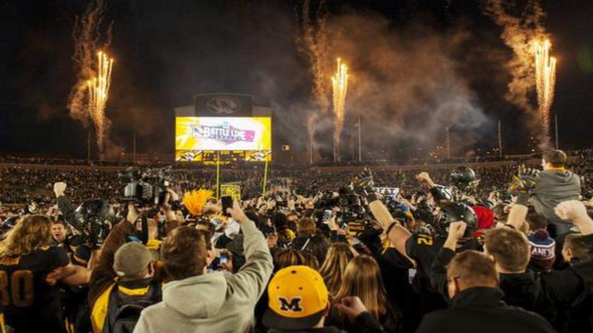 
Missouri fans rushed the field after the Tigers’ 21-14 victory over Arkansas on Friday.
