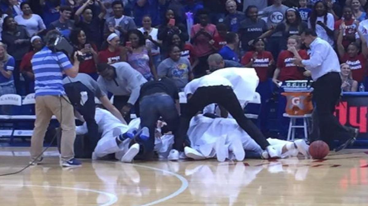 
The Kansas basketball team mobbed the student who won $10,000.
