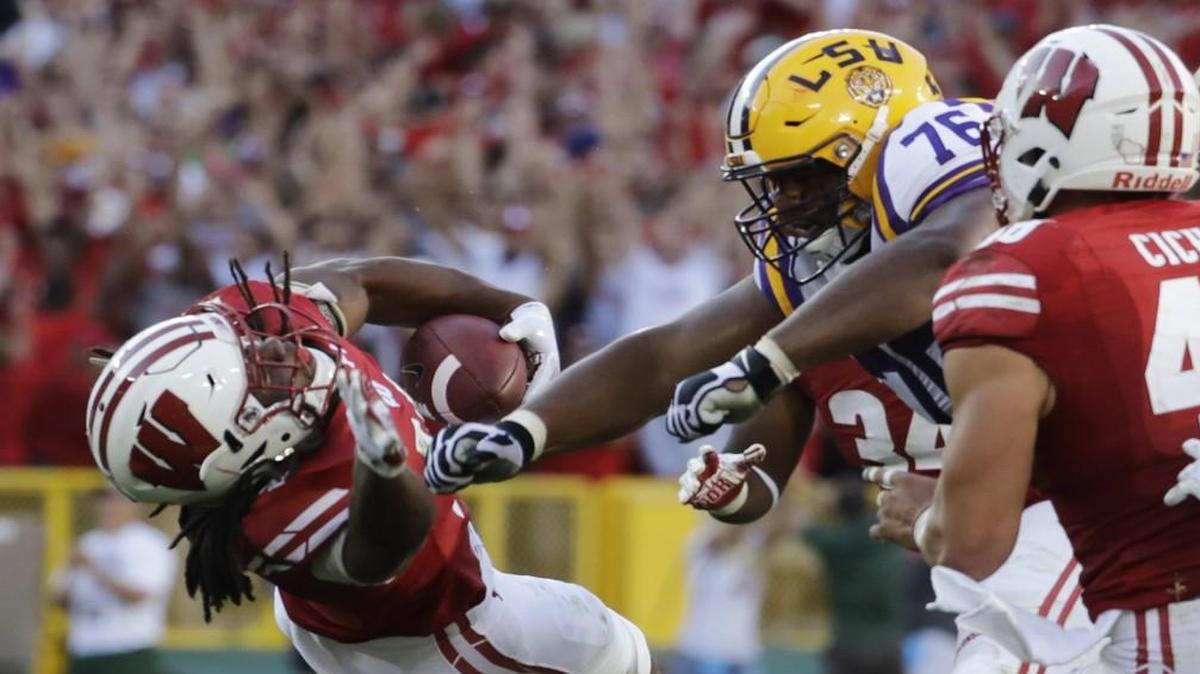 LSU’s Josh Boutte hits Wisconsin’s D’Cota Dixon after Dixon intercepted a pass during in the Badgers’ 16-14 victory.