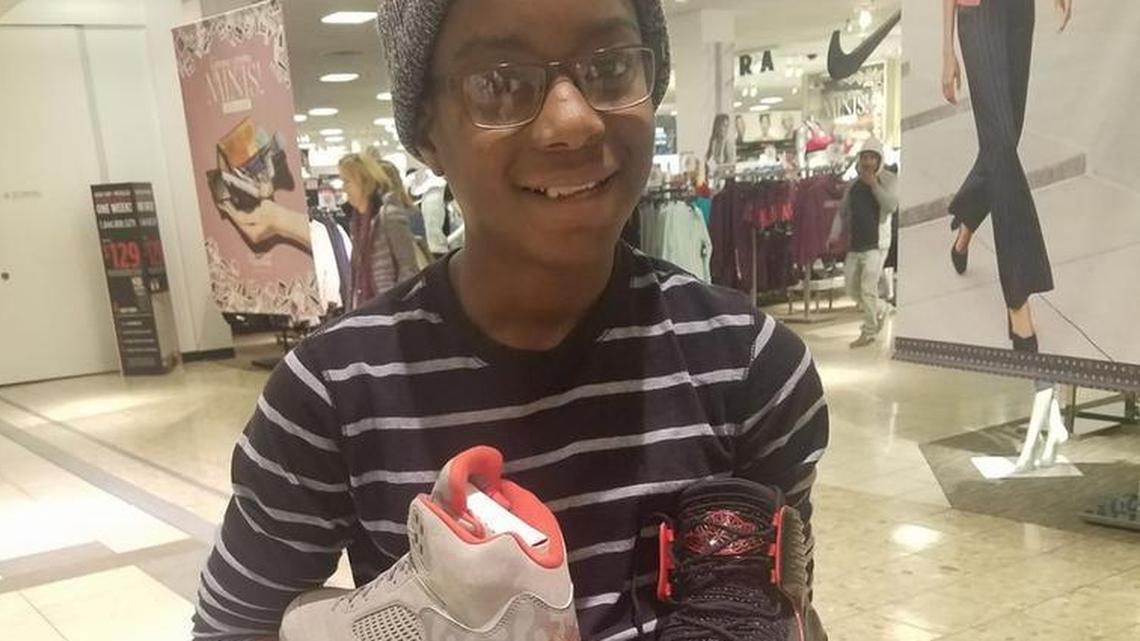 ZaMarion Coffie with one of each of his new shoes.