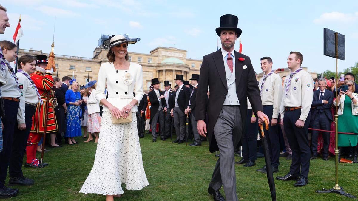 Britain's Catherine, Princess of Wales and Britain's Prince William, Prince of Wales talk to guests during a Royal Garden Party at Buckingham Palace, in London, on May 8, 2026.