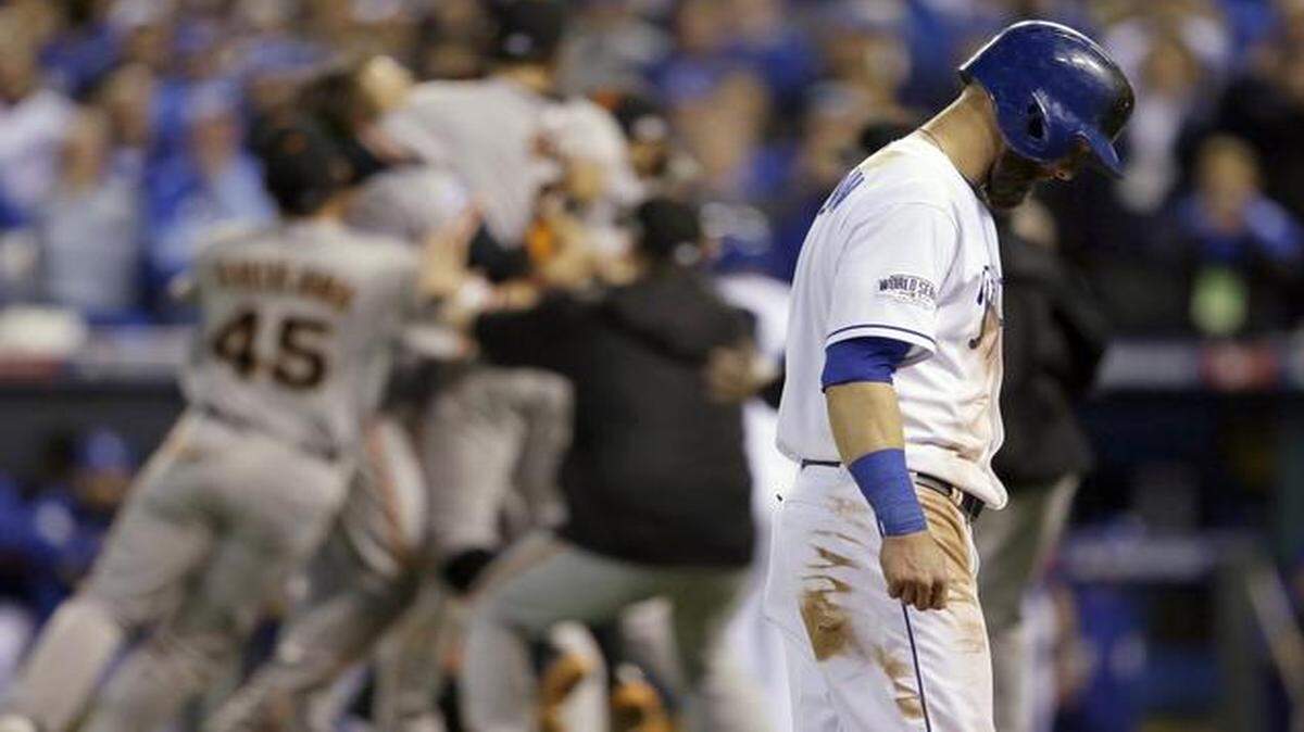 
Alex Gordon walked off the field as San Francisco Giants players celebrates after game seven.
