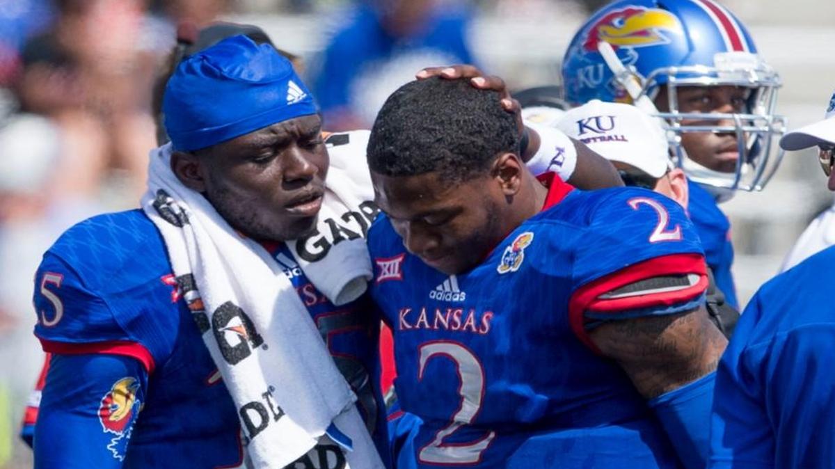 
Kansas receiver Bobby Hartzog Jr (5) checked on quarterback Montell Cozart (2) after Mozart was briefly injured during the second quarter of Saturday’s football game in Lawrence.
