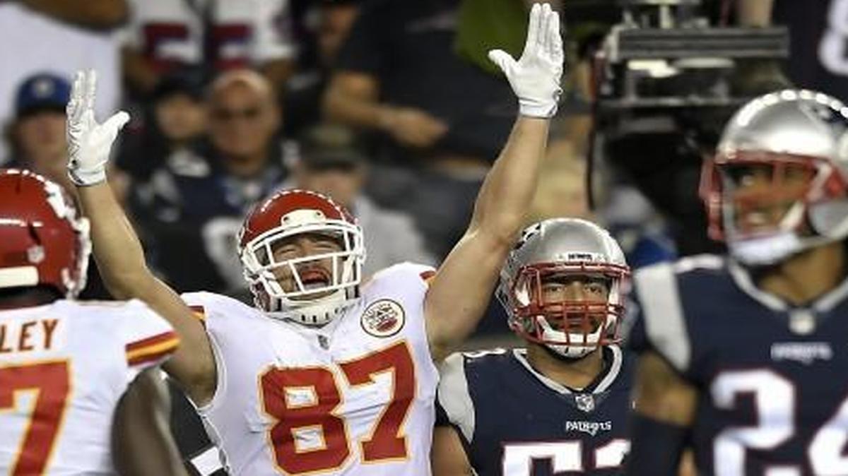 Kansas City Chiefs tight end Travis Kelce signaled touchdown as he stood next to New England’s Kyle Van Noy.