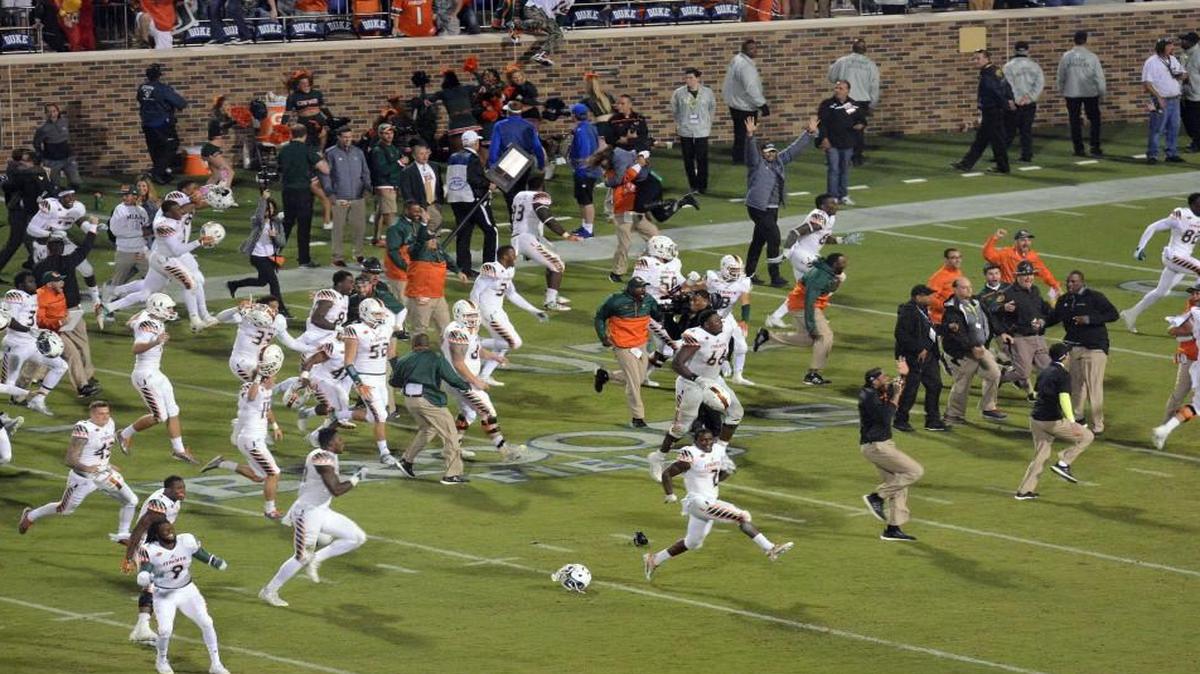 Miami players ran onto the field to celebrate their 30-27 win over Duke in the final seconds of Saturday’s game.